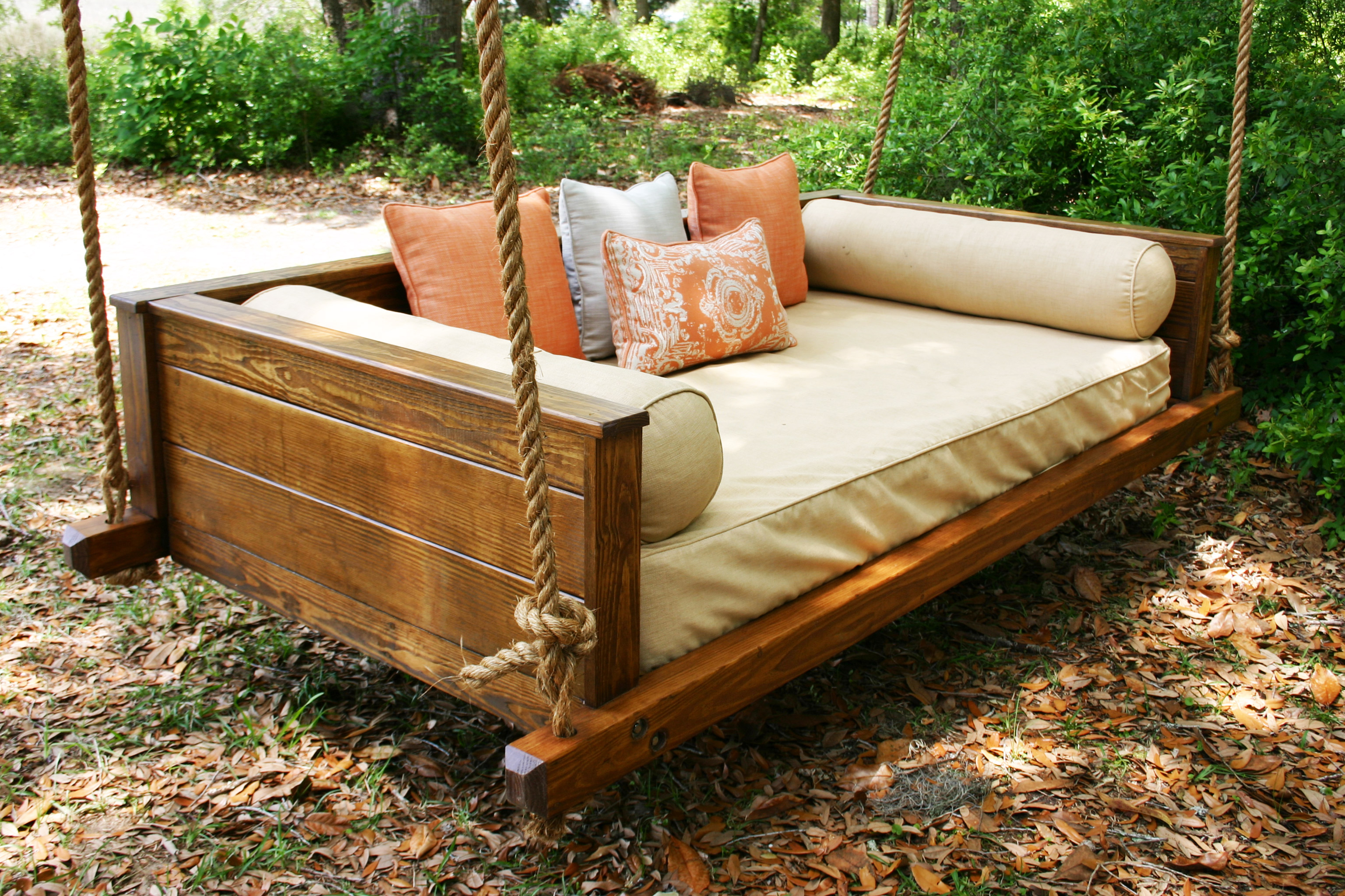 rustic wood patio swing bed with chains and pillows plus bolsters